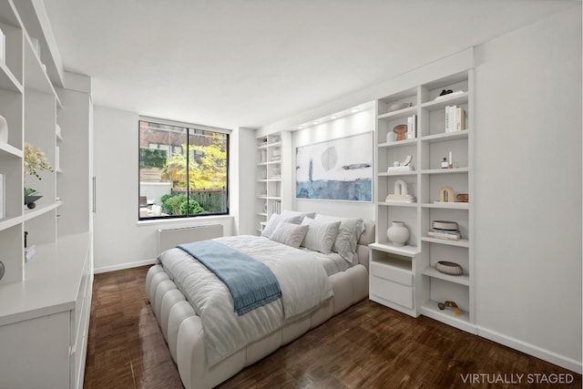 bedroom featuring dark wood-style floors and baseboards