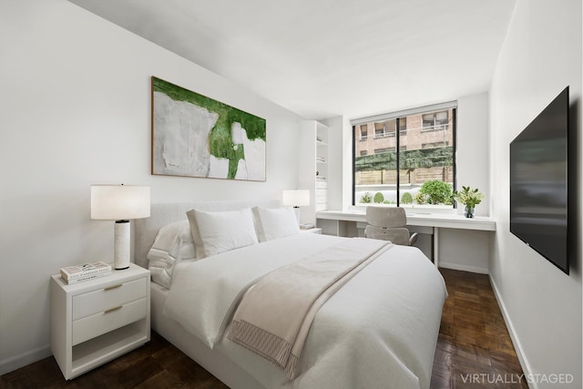 bedroom featuring dark wood-style floors and baseboards