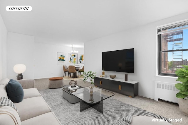 carpeted living room with radiator and a notable chandelier