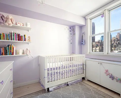 bedroom featuring a nursery area