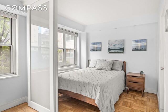 bedroom featuring multiple windows and baseboards