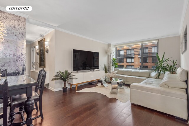 living area with hardwood / wood-style flooring, baseboards, visible vents, and crown molding