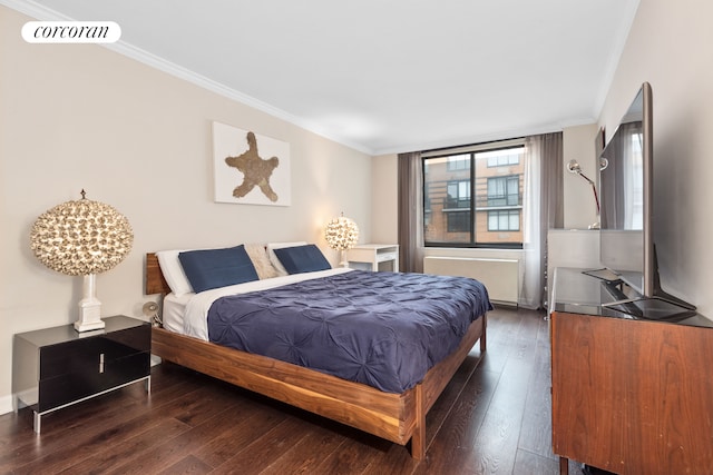 bedroom with radiator, visible vents, wood-type flooring, and ornamental molding