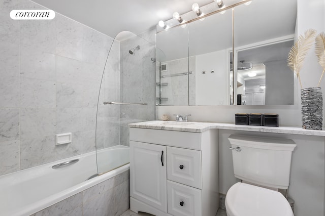 bathroom with tiled shower / bath combo, toilet, and vanity