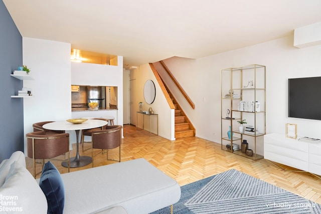 living room featuring stairway and baseboards