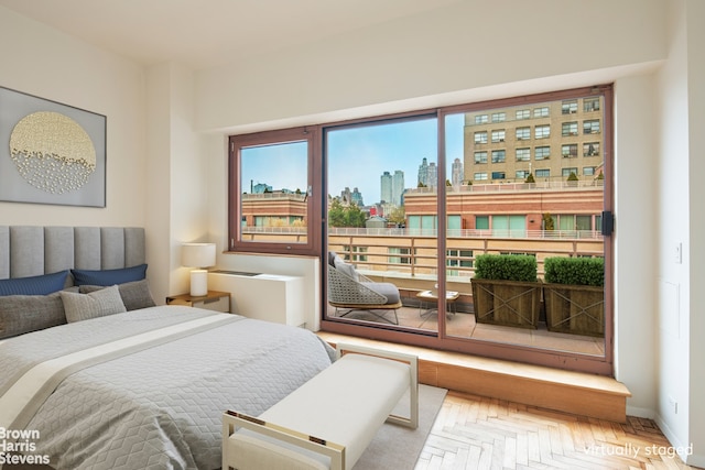 bedroom with a view of city and baseboards