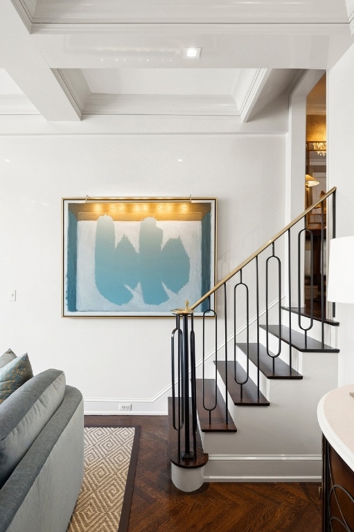 stairs featuring parquet flooring and crown molding