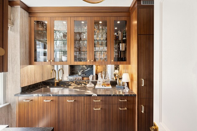 bar with wet bar and a sink