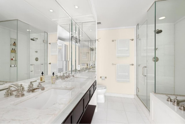 bathroom featuring toilet, tile patterned floors, an enclosed shower, and vanity