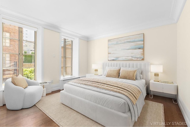 bedroom featuring wood-type flooring and crown molding