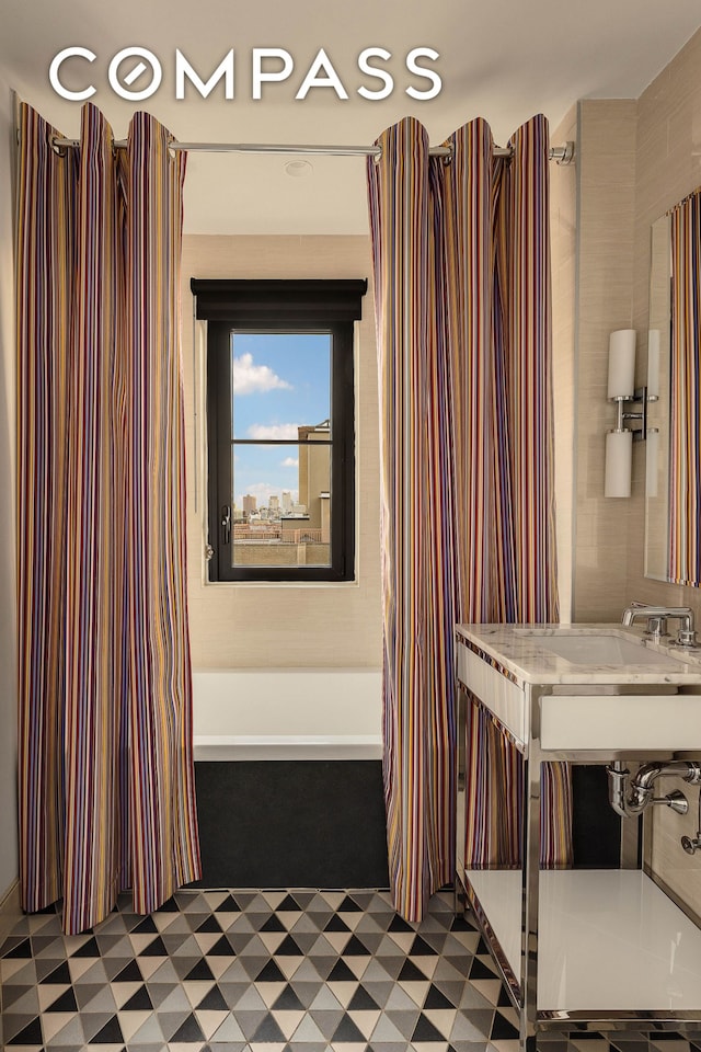 234 E 23rd St Unit 18B, New York City, NY 10010 - bathroom featuring tile patterned floors, a sink, and a shower with shower curtain