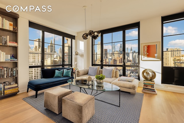 234 E 23rd St Unit 18B, New York City, NY 10010 - living room with a view of skyline and wood finished floors