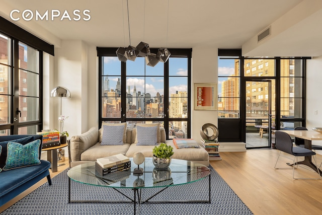 234 E 23rd St Unit 18B, New York City, NY 10010 - living area with wood finished floors, a view of city, and expansive windows