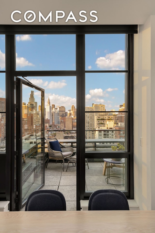 interior space featuring a wall of windows and a view of city