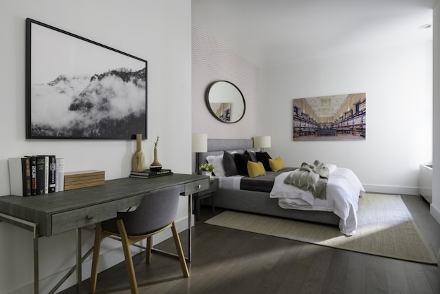 bedroom with baseboards and wood finished floors