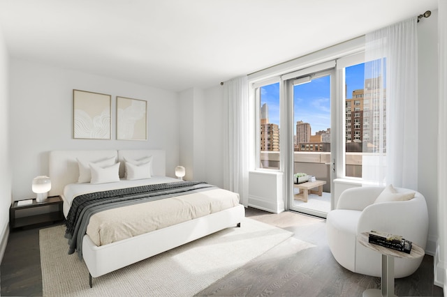 50 Riverside Blvd Unit 17-F, New York City, NY 10069 - bedroom with a view of skyline, wood finished floors, and access to outside