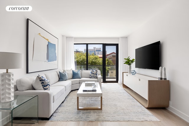 living room with french doors and light hardwood / wood-style floors