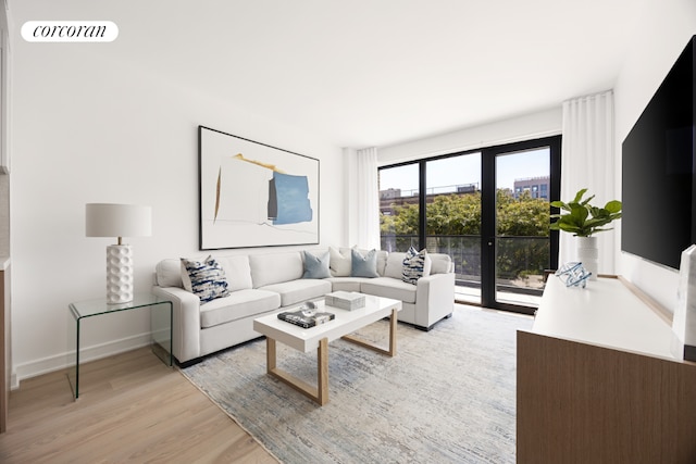 living room with french doors and light hardwood / wood-style floors