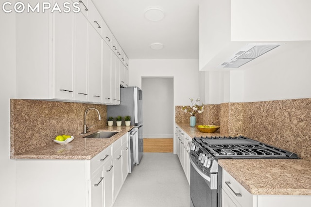 kitchen featuring white cabinetry, extractor fan, gas stove, tasteful backsplash, and sink