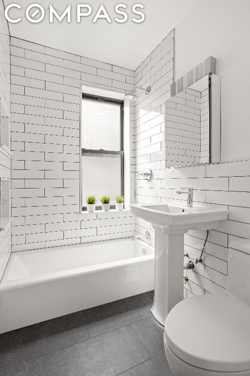 bathroom featuring tile walls, toilet, independent shower and bath, and tile patterned flooring