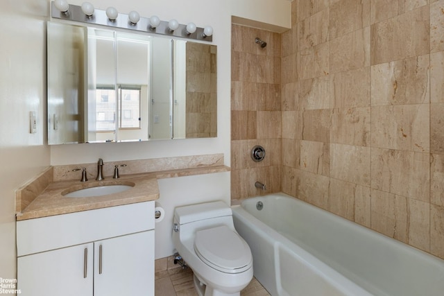 full bathroom with toilet, tiled shower / bath, and vanity