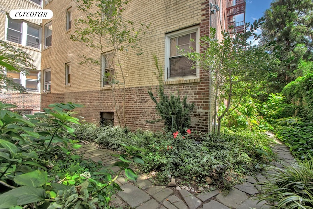 view of side of property featuring brick siding
