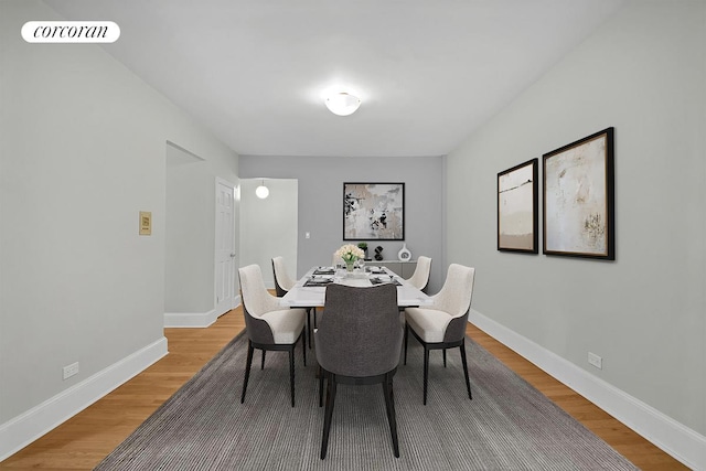 dining area with visible vents, baseboards, and light wood-type flooring
