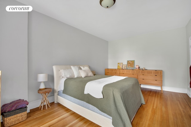 bedroom with light wood-style floors and baseboards