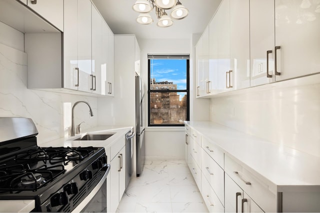 kitchen featuring light stone countertops, a sink, stainless steel appliances, marble finish floor, and backsplash