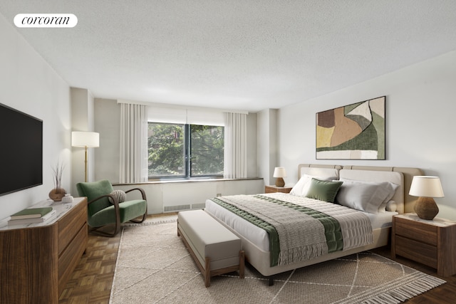 bedroom featuring light parquet floors and a textured ceiling