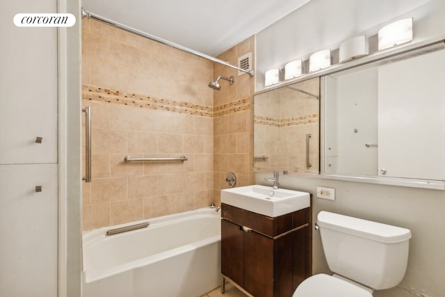 full bathroom featuring toilet, tiled shower / bath combo, and vanity