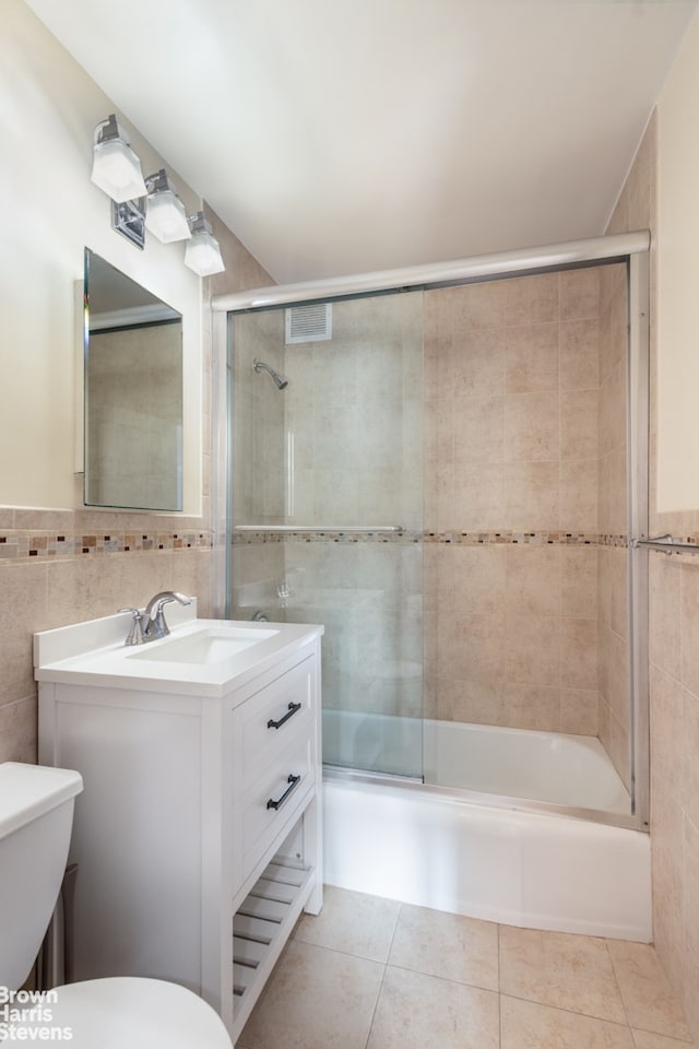 201 E 28th St Unit 17C, New York City, NY 10016 - full bath featuring tile walls, vanity, shower / bath combination with glass door, and tile patterned floors