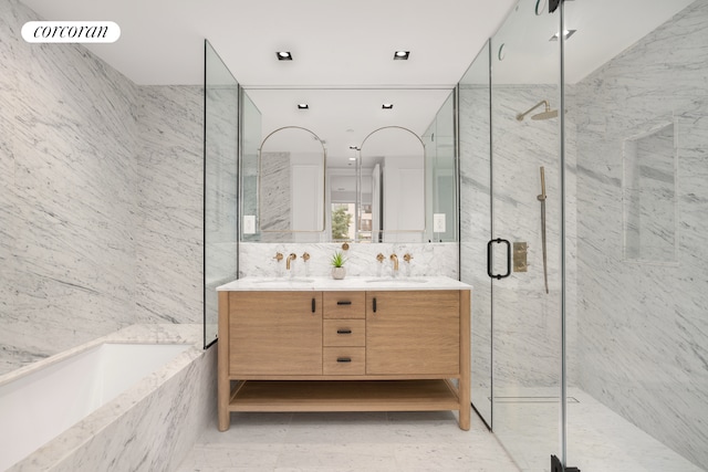 full bathroom featuring a garden tub, a sink, tile walls, and a marble finish shower