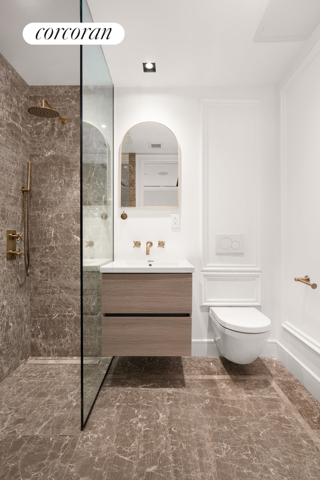 bathroom with vanity, toilet, and a walk in shower