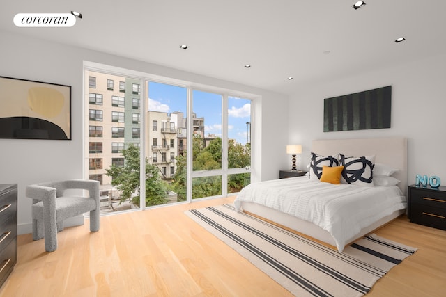 bedroom featuring wood finished floors, visible vents, and recessed lighting