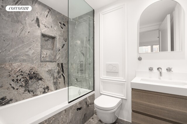 bathroom featuring shower / bathing tub combination, vanity, and toilet