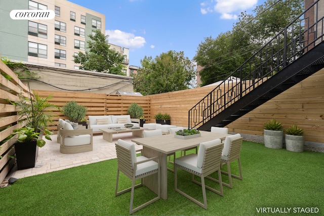 view of patio / terrace with an outdoor hangout area, outdoor dining space, fence, and stairs