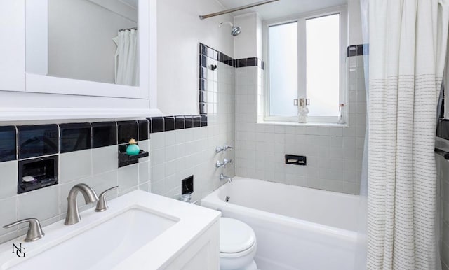 full bathroom featuring tile walls, vanity, toilet, and shower / bathtub combination with curtain