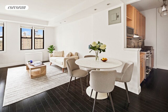 dining space with baseboards, visible vents, and dark wood finished floors