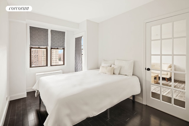 bedroom with baseboards, visible vents, and dark wood finished floors