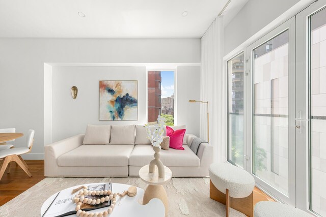 living room with plenty of natural light and wood finished floors