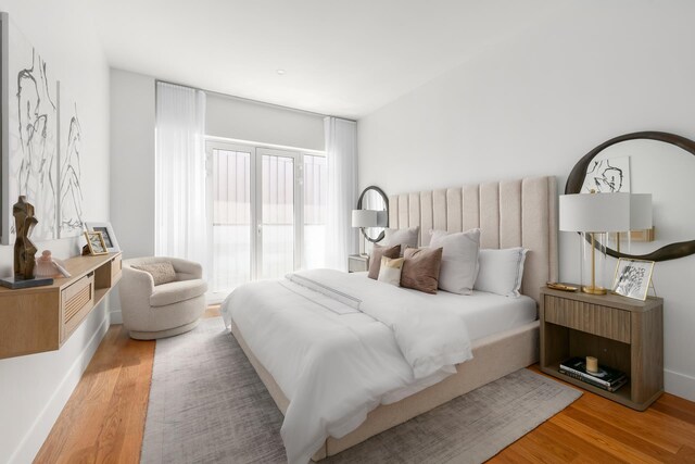 bedroom featuring baseboards and wood finished floors