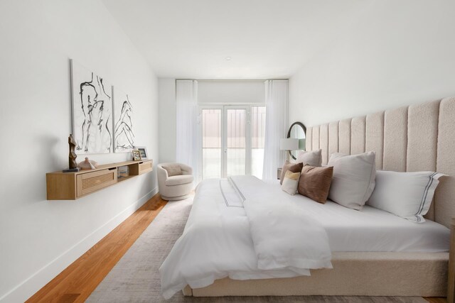 bedroom featuring baseboards and wood finished floors