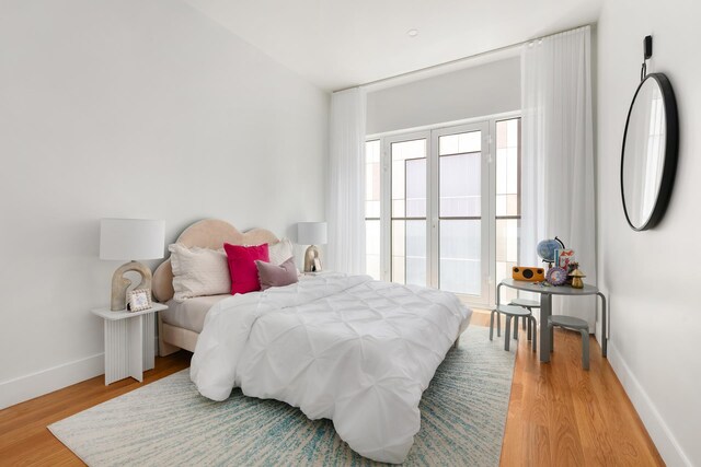 bedroom featuring light wood-type flooring and baseboards