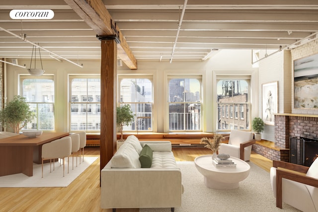 sunroom with visible vents, a healthy amount of sunlight, and a fireplace