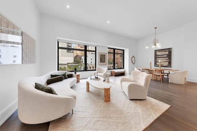 living room with hardwood / wood-style floors and an inviting chandelier