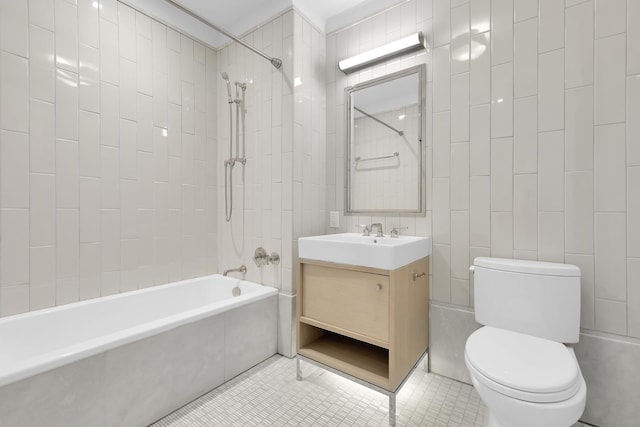 301 E 50th St Unit 4D, New York City, NY 10022 - full bath with toilet, shower / washtub combination, vanity, tile patterned floors, and tile walls