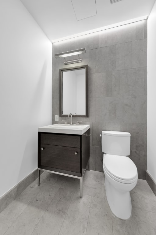 bathroom with toilet and vanity