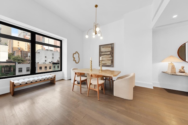 301 E 50th St Unit 4D, New York City, NY 10022 - dining room featuring wood finished floors, baseboards, and a chandelier