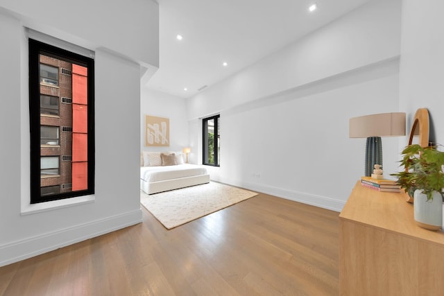 interior space featuring baseboards, recessed lighting, and wood finished floors